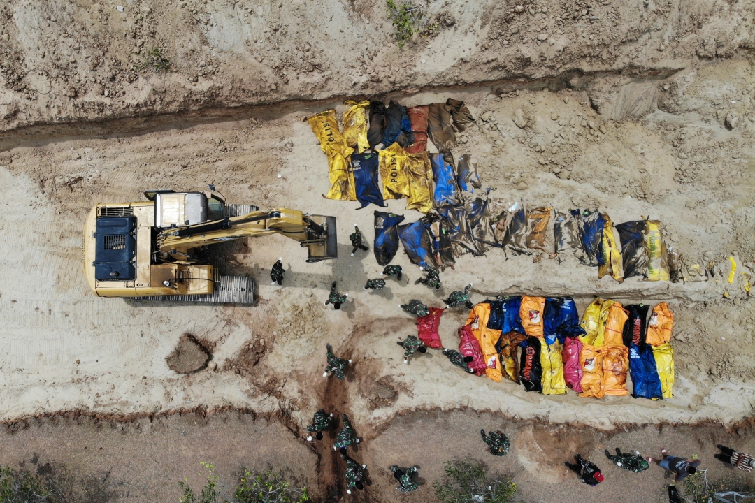 Indonésios enterram vítimas do terremoto em uma vala comum em Poboya
(Foto: AFP PHOTO / Jewel SAMAD; Ola Gondronk; Adek BERRY; Mohd RASFAN)