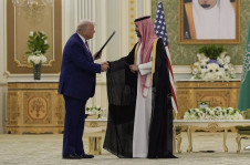 O presidente Donald Trump (E) e o príncipe herdeiro saudita Mohammed bin Salman apertam as mãos após trocar documentos durante uma cerimônia de assinatura no Palácio Real em Riad, Arábia Saudita, 13 de maio de 2025
